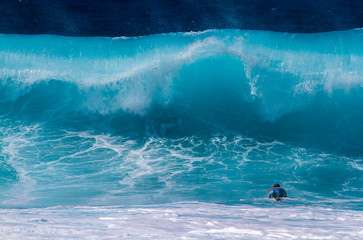 A Surfer diving under a big wave - 297027894