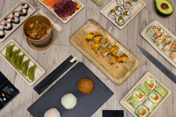 Variety of typical Japanese food. top view. Sushi rolls, hosomaki, maki yakisoba, mochi, urimaki and vegetable gyozas. japanese food concept