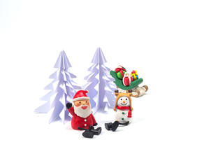 Santa and snow man sat in front of origami christmas tree , with sleighl full of gists waiting for the festival of happiness