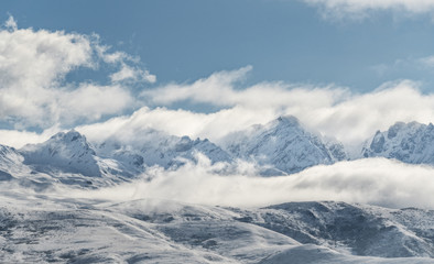 Fototapeta na wymiar Panoramic snow mountain with white clouds and blue sky 