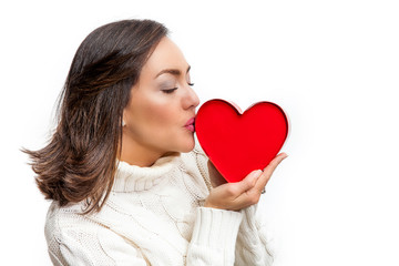 Happy beautiful woman holding a red heart on her hands isolated on white background. Conceptual for love, healthcare, cardiology