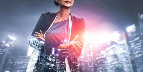 Double Exposure Image of Business Person on modern city background. Future business and communication technology concept. Surreal futuristic cityscape and abstract multiple exposure graphic interface. © InfiniteFlow
