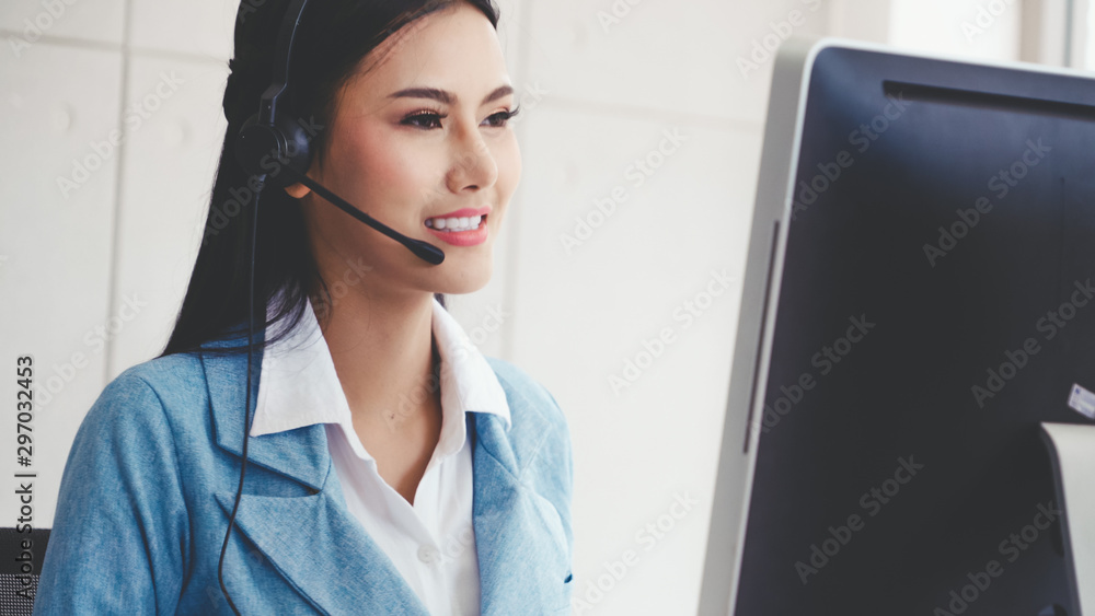 Poster customer support agent or call center with headset works on desktop computer while supporting the cu