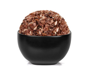 brown rice in the black bowl isolated on white background