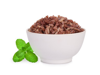 brown rice in the white bowl with mint leaf isolated on white background