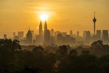 Majestic sunrise over downtown Kuala Lumpur, a capital of Malaysia. Its modern skyline is dominated by the 451m-tall Petronas Twin Towers. 