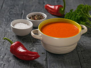 Two bell peppers with cream soup and seasonings on a wooden table.