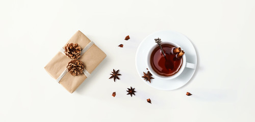 Cup of tea with a gift box - overhead view flat lay