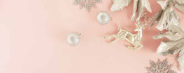 Christmas background banner. Xmas or new year silver color decorations on pastel pink background with empty copy space for text.  holiday and celebration concept for postcard or invitation. top view 