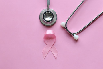 Pink ribbon and stethoscope on pink background, Symbol of breast cancer in women, Health care concept