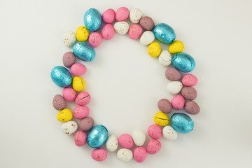 Pastel Colored Chocolate Easter Eggs In A Circle On A White Studio Background