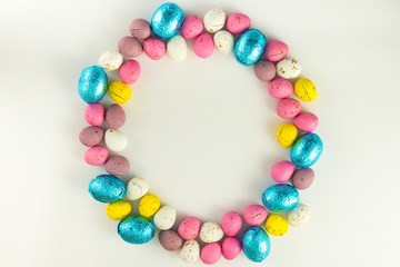Pastel Colored Chocolate Easter Eggs In A Circle On A White Studio Background