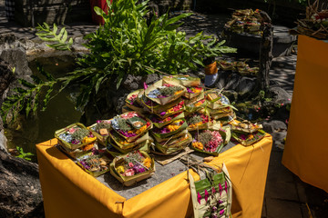 Table full of Hindu religious offerings ACat the Balinese ceremony