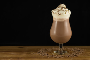 Delicious Creamy Chocolate Milkshake On Timber Board With Black Background In A Studio