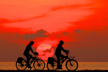 silhouette happy family  and bike  on sunrise