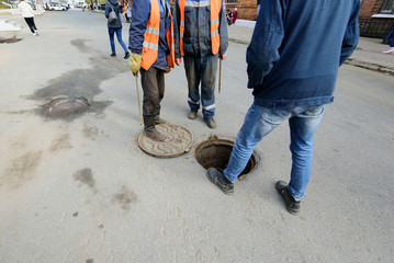 Sewerage accident. Workers pump water.