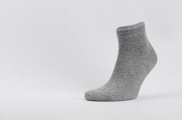Grey black cotton sock medium size on invisible foot as mock up for advertising, branding, design....