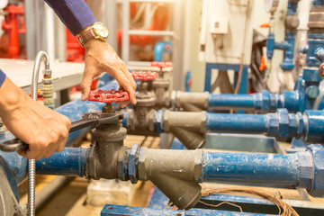 Plumber repairing and performing maintenance big water pipes.