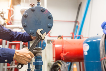 Plumber repairing and performing maintenance big water pipes.