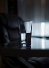 half empty glass in an empty room esoteric