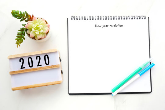 2020 Resolution On Blank Notebook Paper Over White Marble Background, 2020 New Year Mock Up, Template, Flat Lay