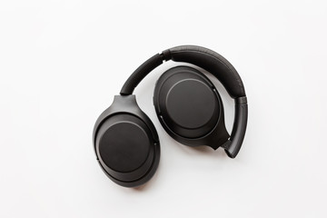 Fototapeta na wymiar Black modern wireless headphones on white background . Technology concept, minimal flat lay style, mockup, template, top view, overhead