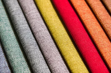  Colorful and bright fabric samples of furniture and clothing upholstery. Close-up of a palette of textile abstract diagonal stripes of different colors © yanik88