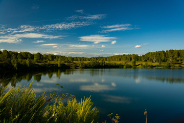 Fototapeta na wymiar Landscape with lake and blue sky