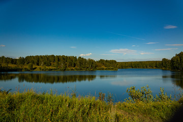 Fototapeta na wymiar Landscape with lake and blue sky