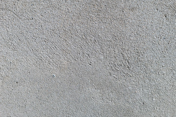 Gray textured cement wall background with fine concrete chips. Construction backgrounds