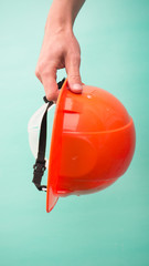 construction helmet in hands on a blue background