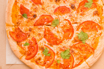 Top view fresh delicious pizza Margarita on the table, close-up photo of food