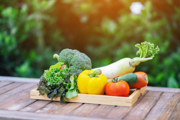 A fresh mixed vegetables in a wooden tray on the table