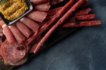 jerky and sausage with french mustard on stone table
