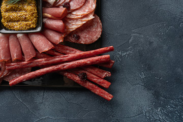 jerky and sausage with french mustard on stone table