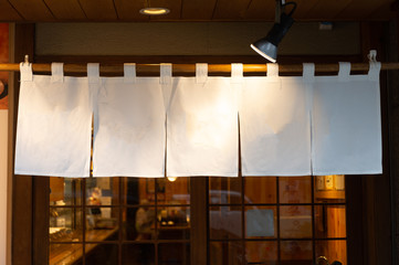 The curtain-like fabric that hangs in front of traditional Japanese restaurants and shops not only serves as a signboard, but holds a larger meaning,