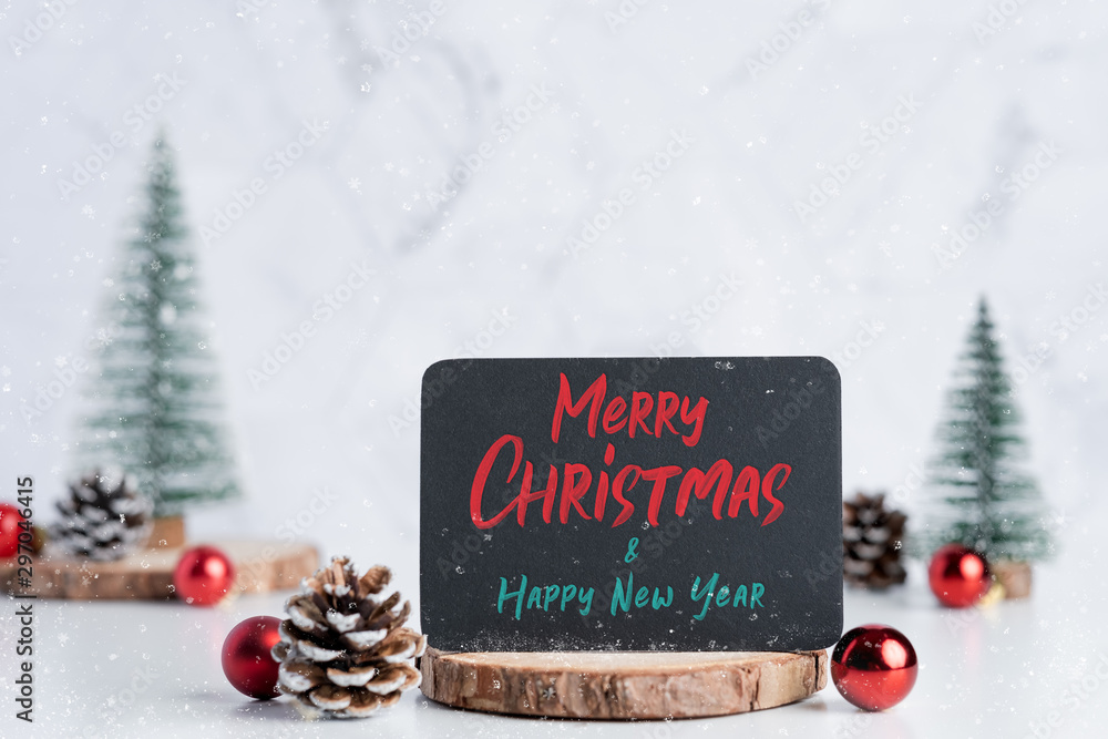 Aufkleber merry christmas and happy new year on blackboard with christmas tree with pine cone and decor ball o