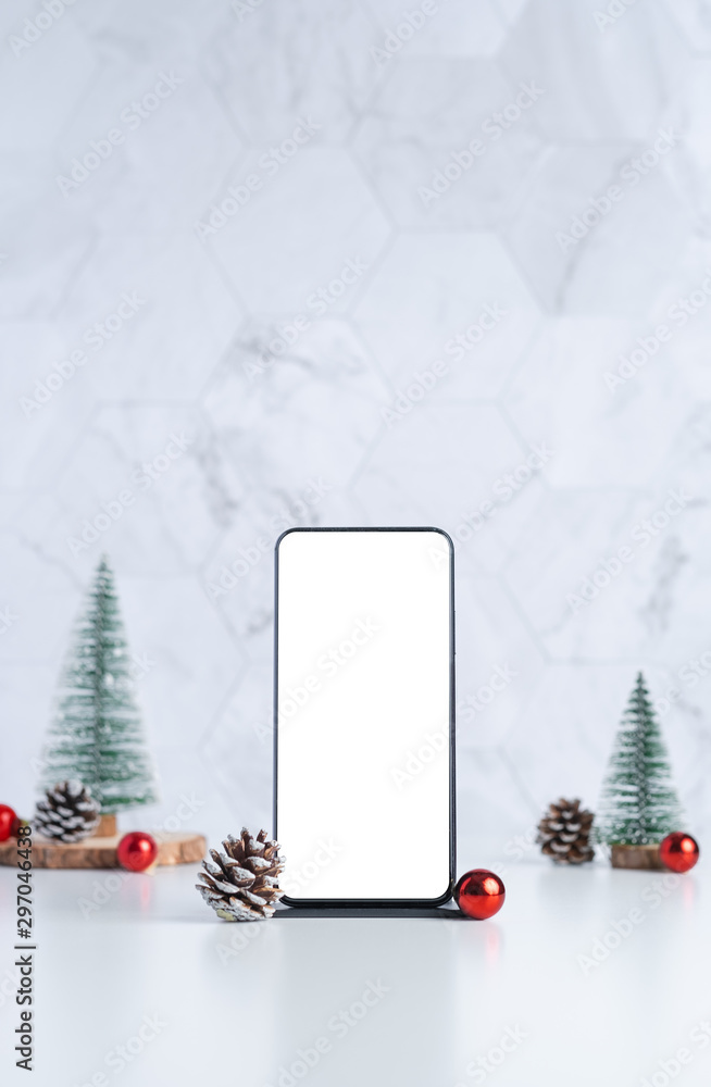 Poster mockup screen mobile with christmas tree with pine cone and decor xmas ball on white table and marbl