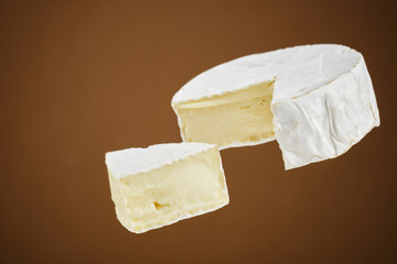 closeup view of camembert cheese on brown background. brie cheese. macro shot