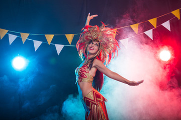 Holidays, party, dance and nightlife concept - Beautiful woman dressed for carnival night