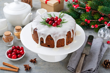 Traditional Christmas fruit cake, pudding with dried fruits, nuts and white glaze.