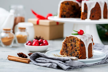 Traditional Christmas fruit cake, pudding with dried fruits, nuts and white glaze.