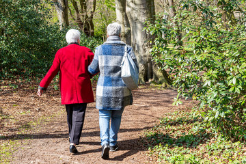 A woman takes her mother with Alzheimer out for a walk through the park in Ockenburg, Netherlands