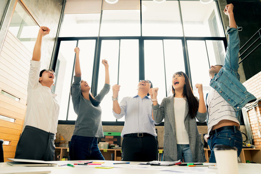 successful startup new business teamwork group of business people hand up raise to sky together with cheerful and exited emotion