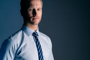 smart caucasian businessman white shirt portrait half body dark color background