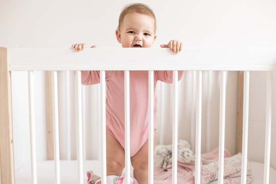 Baby Girl Standing In Bed  