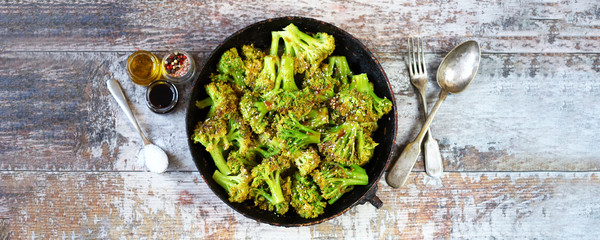 Baked broccoli in a pan with sesame seeds. Healthy food. Vegan lunch. Keto diet.