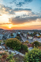 Fototapeta na wymiar Autumn sunset over Plovdiv city, Bulgaria. European capital of culture 2019 and the oldest living city in Europe. Photo from one of the hills in the city.