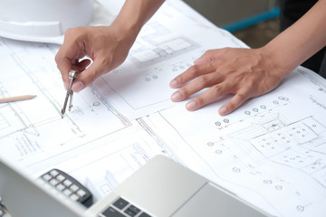 architect engineer working on house blueprint of real estate project. building construction concept.