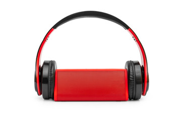 Red small audio speaker with headphones on white.